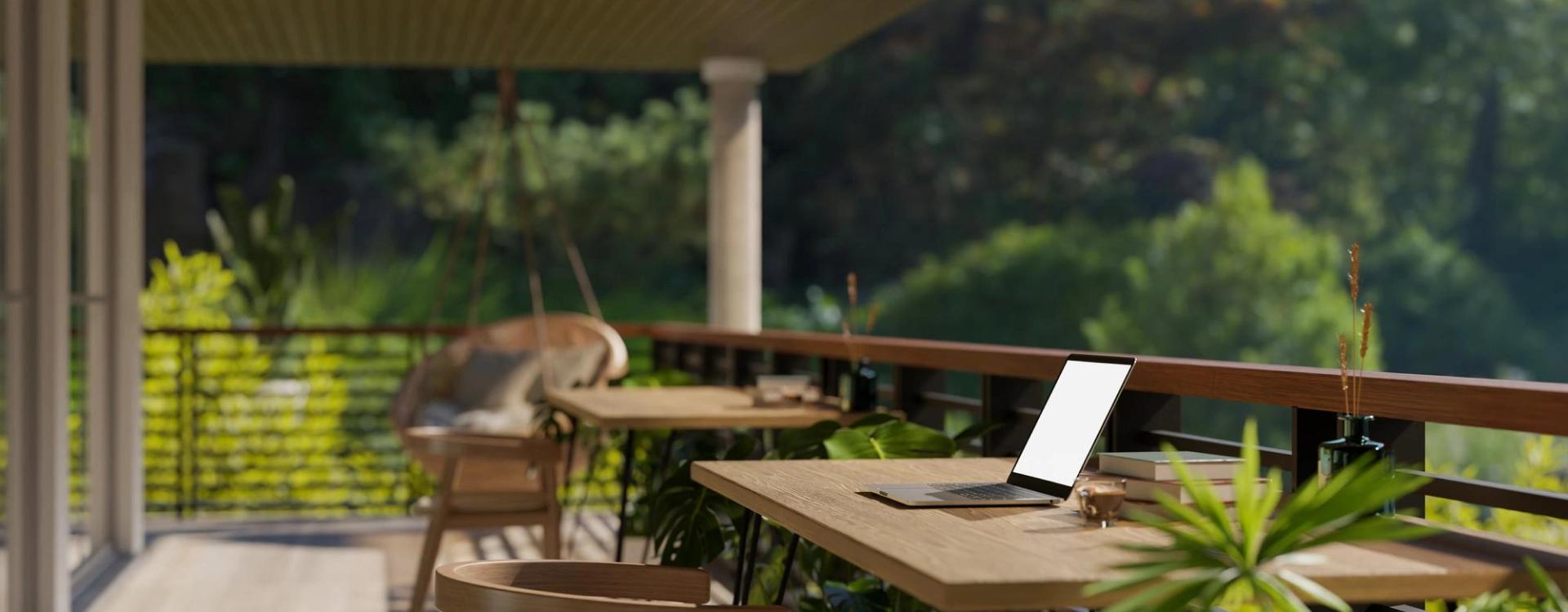 Laptop on outdoor table in serene setting